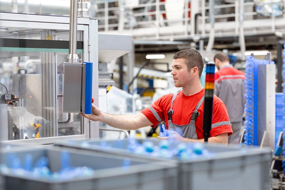 An employee operating a production machine in the Henkel plant in Kruševac, Serbia