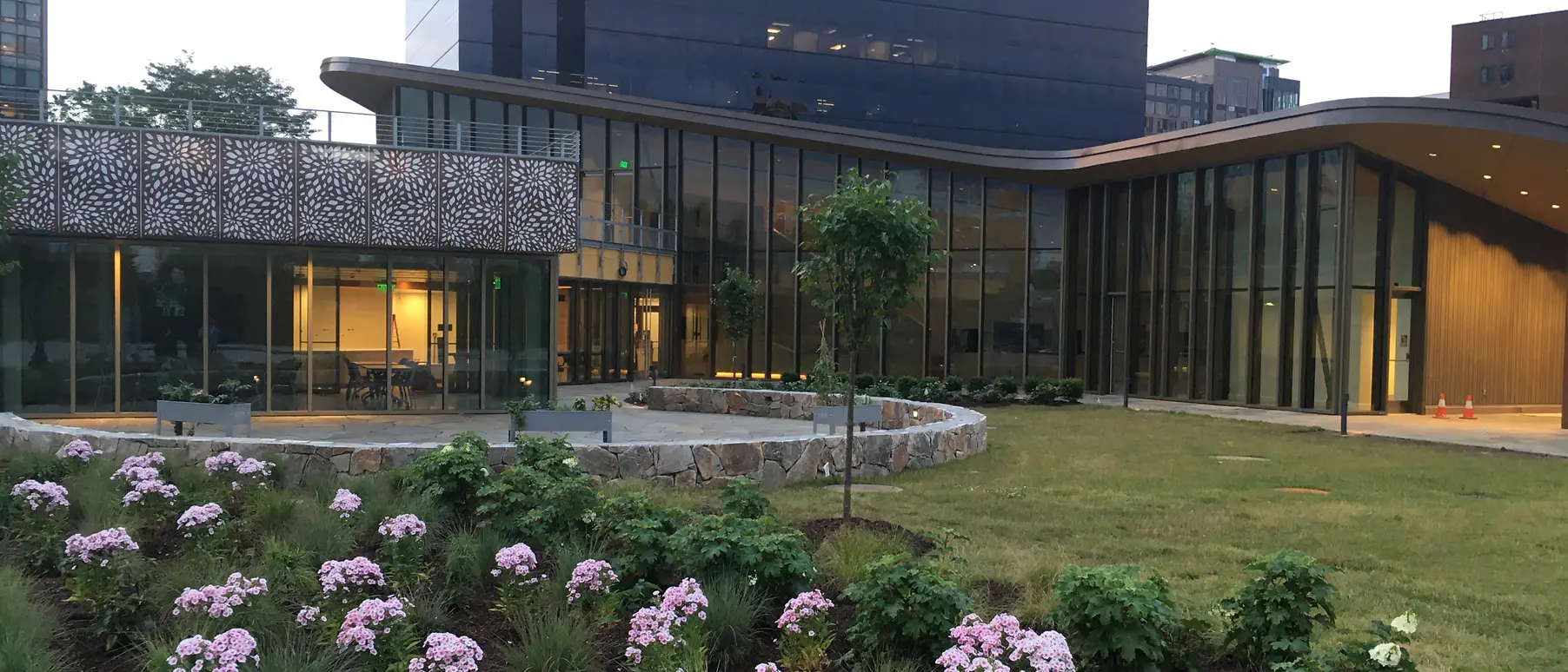 Flower bed in foreground of building with glass walls