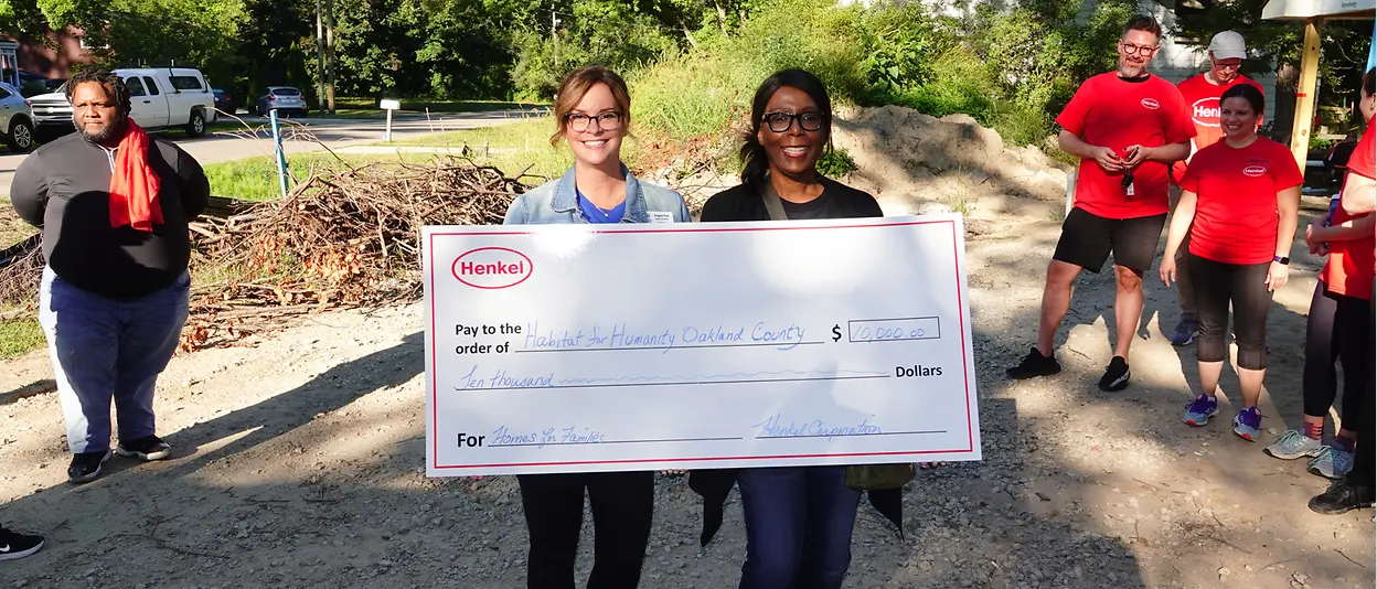 Two women holding oversized check