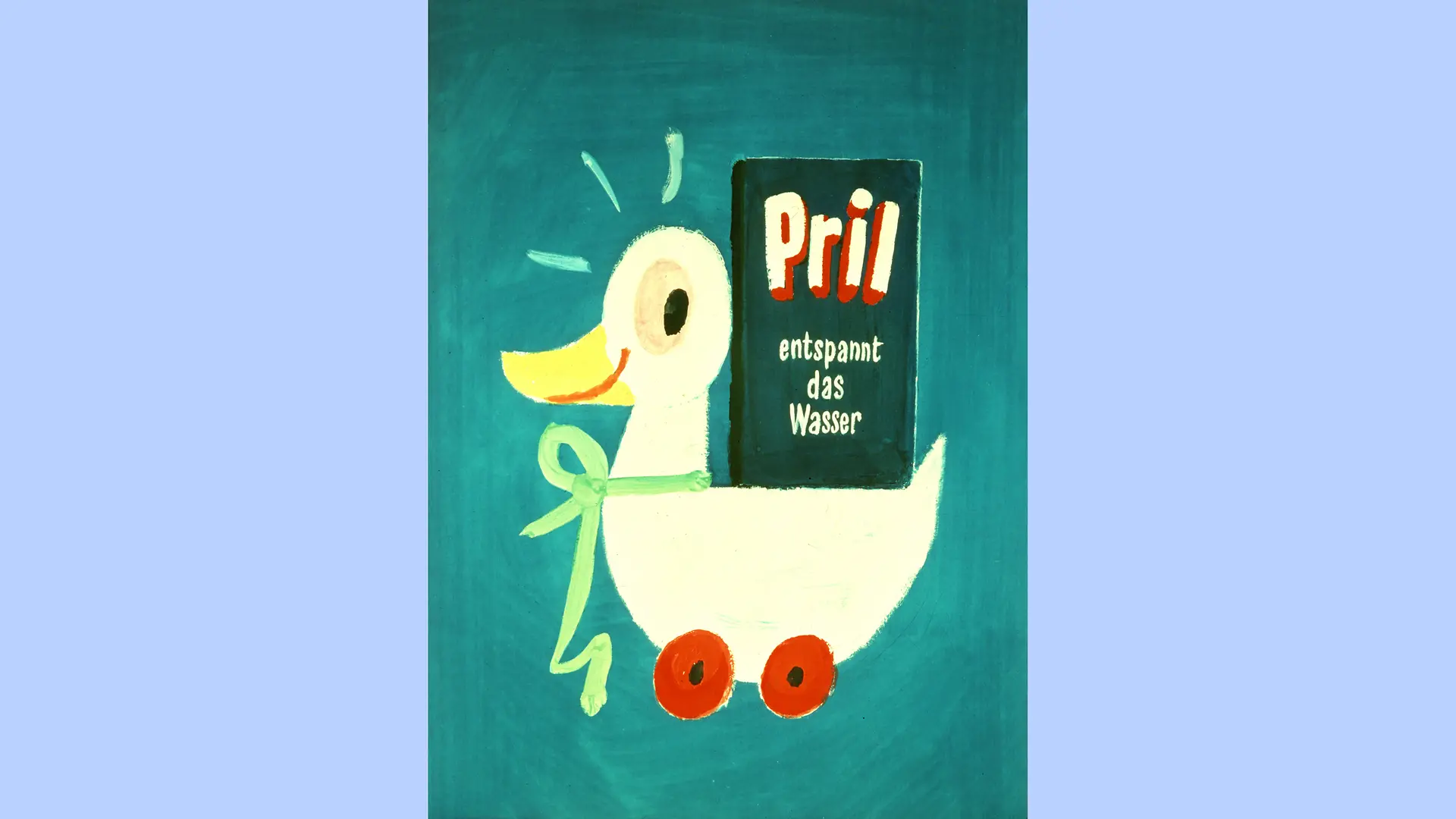 Un dessin de la célèbre “Pril Duck”, portant un ruban vert autour du cou. Un paquet de Pril avec l’inscription “entspannt das Wasser” (“adoucit l’eau”) est posé sur son dos. Le canard regarde le paquet de côté avec une expression joyeuse.