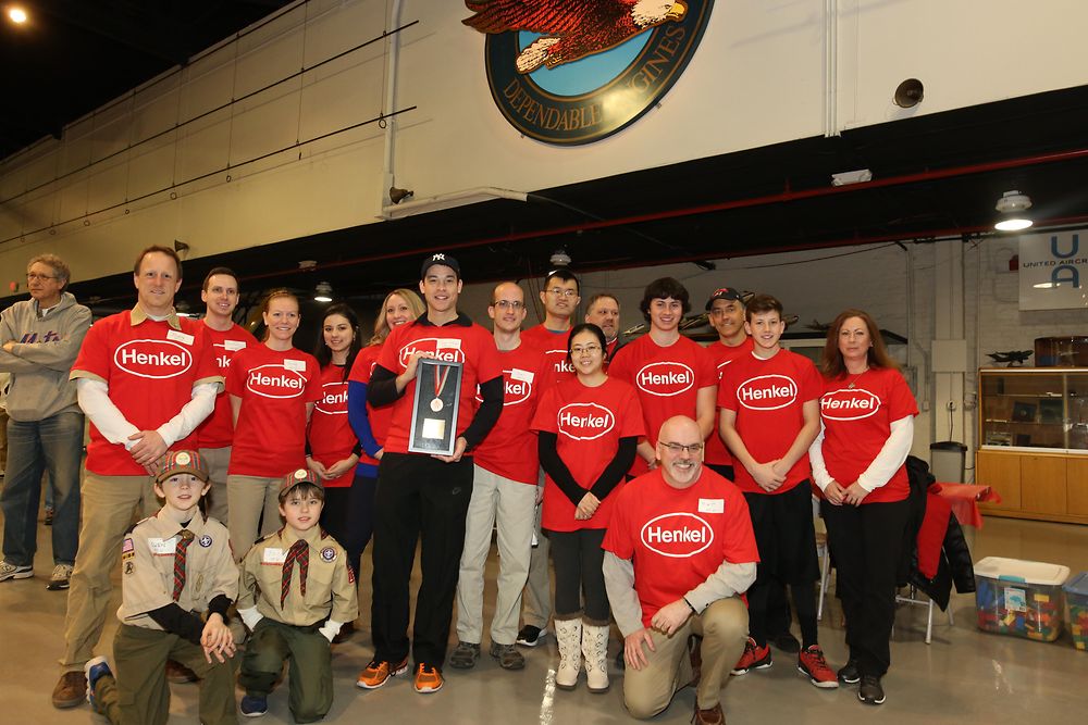 Following an awards presentation held during the opening ceremony of the Special Olympics Connecticut Winter Olympics, Henkel employees proudly display the award presented by SOCT recognizing Henkel’s support of the organization.
