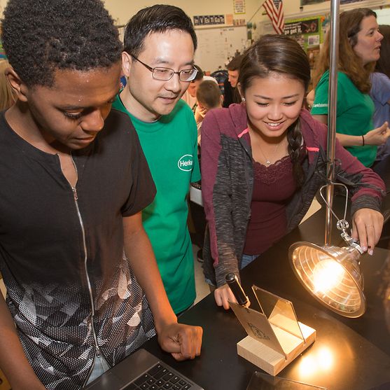Henkel’s Senior Research Scientist Stanley Kong teaches students about the thermal properties of solar film. 