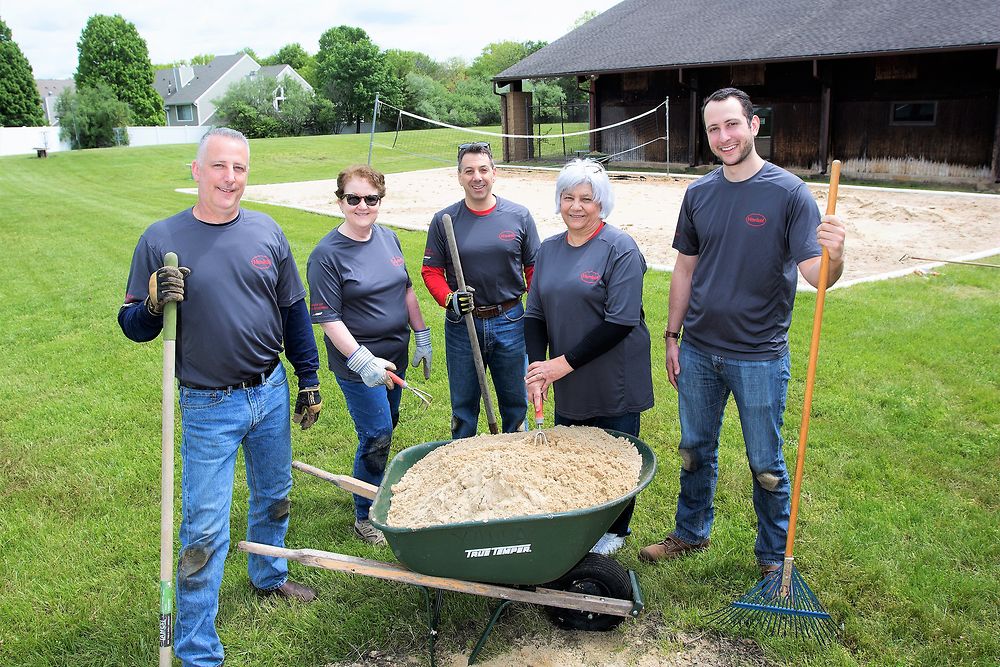 Volunteers prepare the grounds for YMCA’s summer camp.