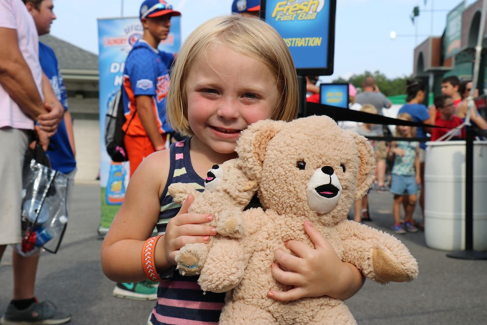 A girl with her Snuggle® bears at the 2017 Little League® Baseball World Series in Williamsport, PA
